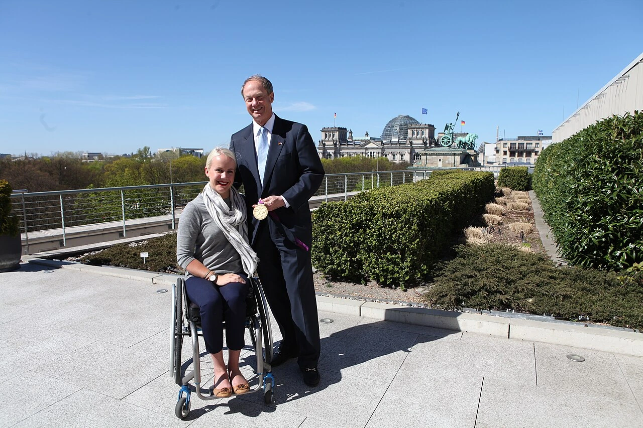 Mallory Weggemann standing outdoors with John B. Emerson on a rooftop in Berlin