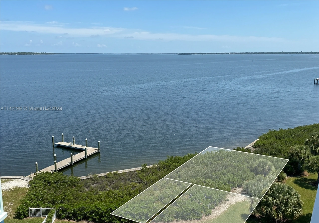 Elevated Tampa waterfront view with faint parcel boundary lines over land and water.